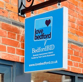 Swinging blue sign
with the words BedfordBID