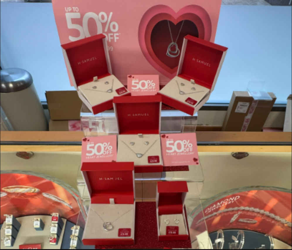 red boxes of jewellery with posters saying 50% discount