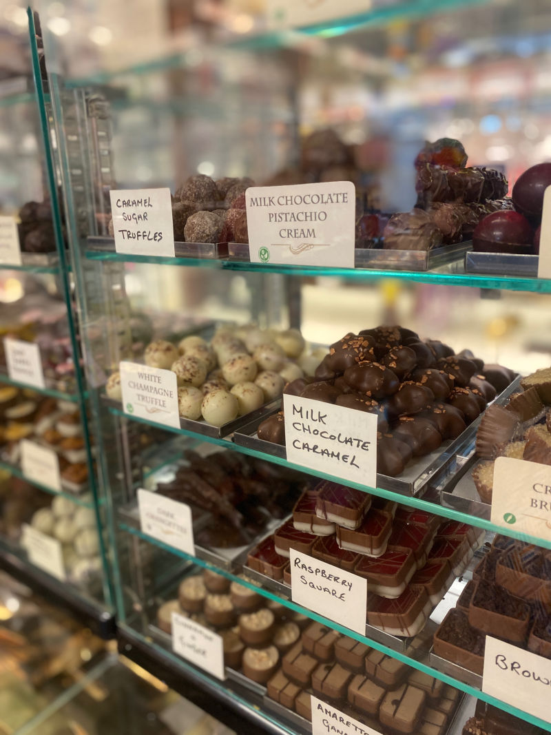 fresh chocolates on glass shelves in Arcadia Sweet Shop.