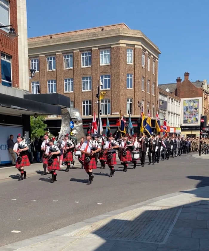 Armed forces day with pipers piping in kilts along the High Street in Bedford.