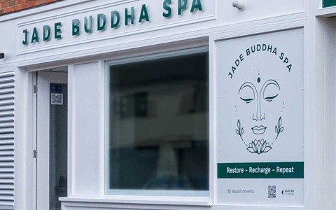 Jade Buddha Spa shopfront with white boarding and green logo and wording