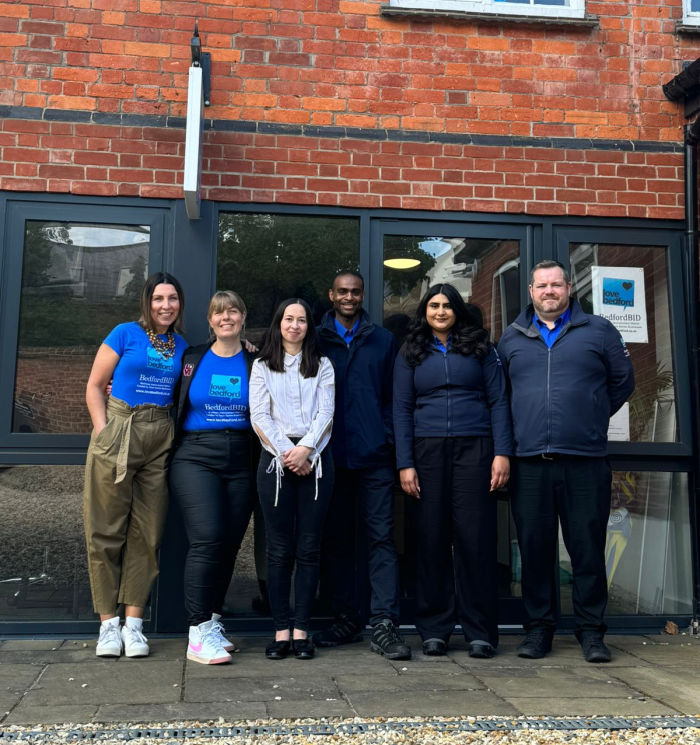 BedfordBID Team ladies and gentlemen stood outside the office building in a row.