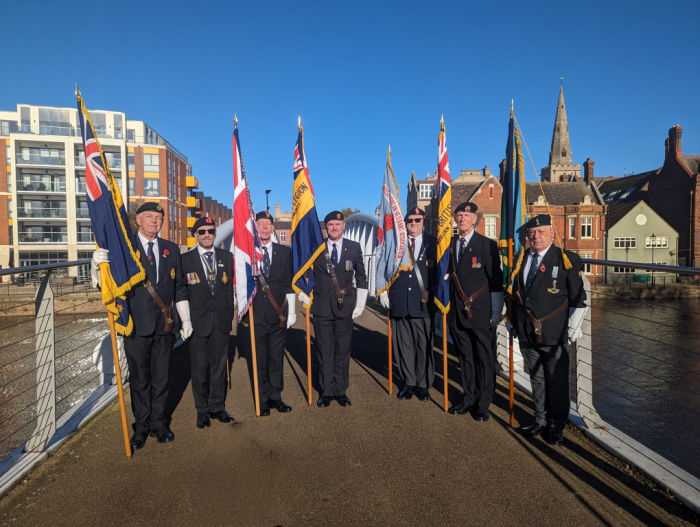 Veterans holding flags at Armistice Day in Bedford.