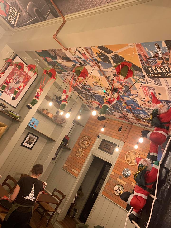 Mural painted restaurant ceiling and art displayed on walls
