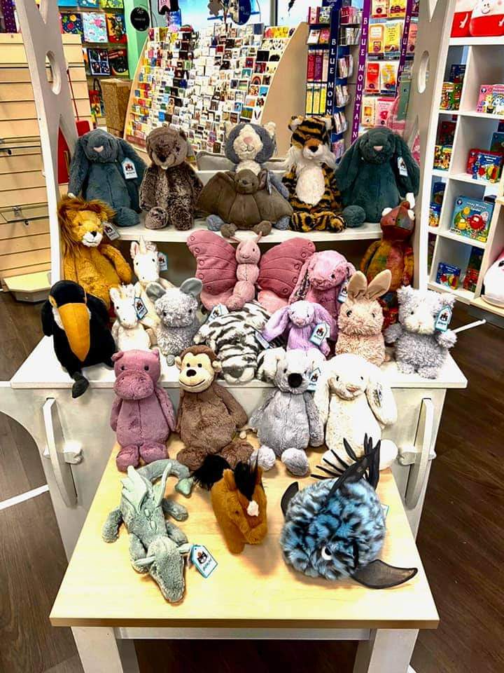 Three tables of different height displaying a variety of animal cuddly toys