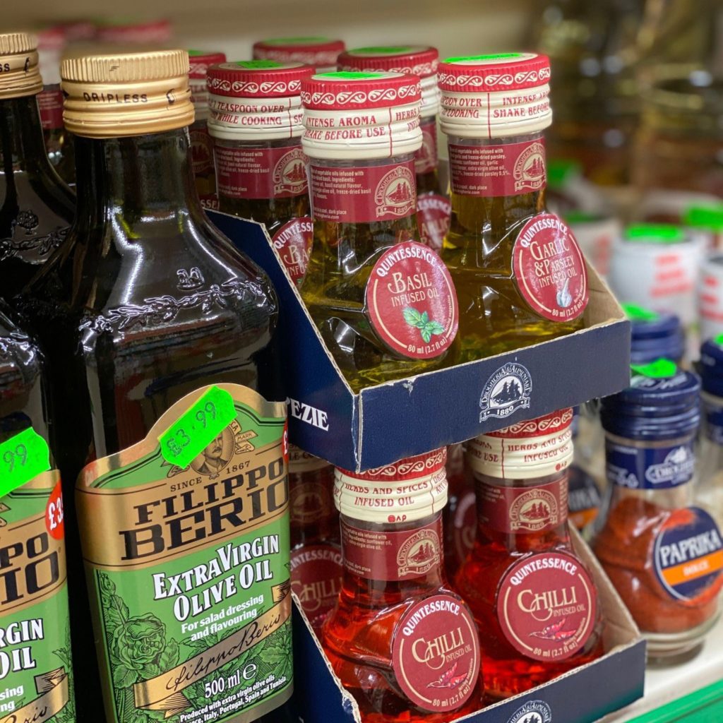 Different types of olive oil, bottled on a shelf