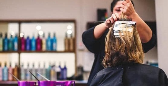 5thAve hairdresser doing foil highlights on a customer