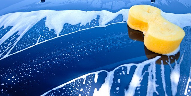 Advanced Valeting showing yellow soapy sponge on blue car bonnet