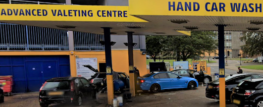 Advanced Valeting street view showing cars to be washed with yellow and blue signage and surround