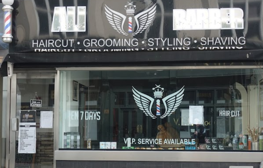 Ali Barber shopfront black background with white writing and angel wings