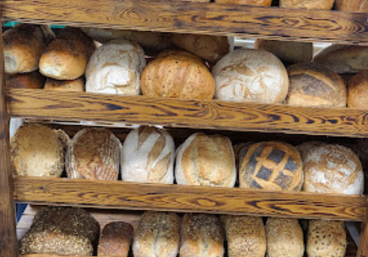 Artisan Bakery fresh loaves of bread on wodden shelves