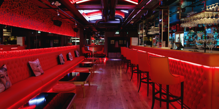 Astons Bar with banquette with red, black and orange decor