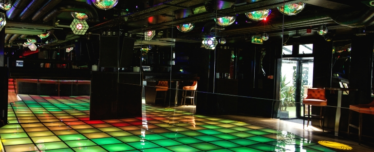 Astons Saturday night fever themed dancefloor with coloured light tiles and disco balls