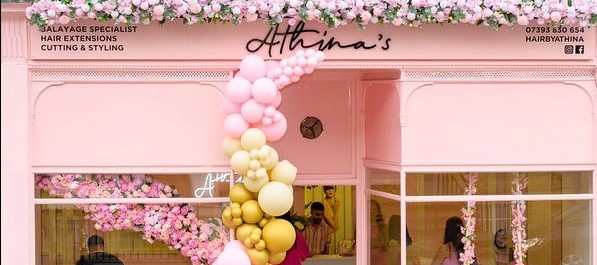 Athina Barbie-pink shopfront with floral display and balloon arch