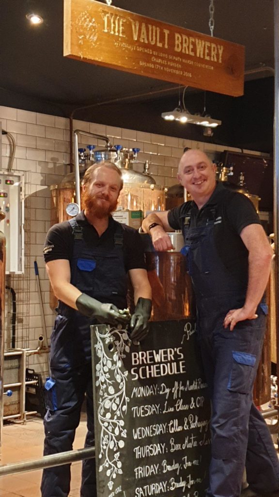 Brewhouse happy staff with specials blackboard