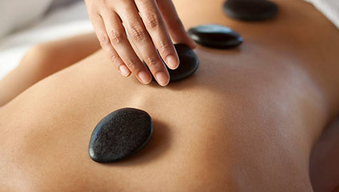 hot stone massage on a woman's body.