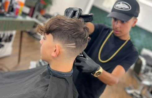Damiano Hair showing barber and male customer having a cut and patterns