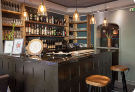 Deshi counter with bar, stools and glass lighting