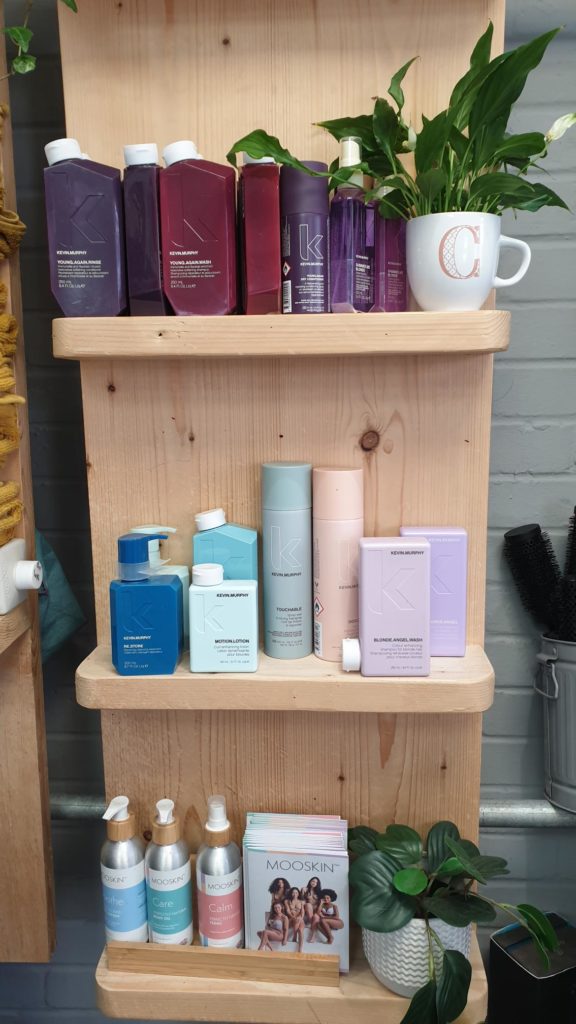 EI Styling Kevin Murphy products on wooden shelving with plants