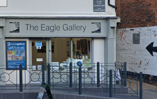 Eagle Gallery shopfront black writing on grey background and fascia