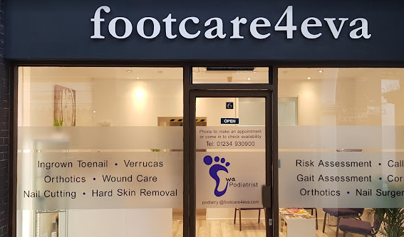 Footcare4Eva shopfront with glass windows, and signage in white writing on dark grey