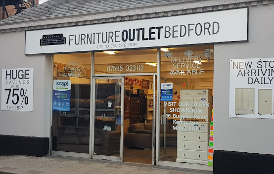 Furniture Outlet shopfront with black wording on white background