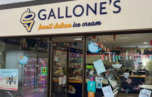 Gallone's shop window with logo, promotional offers in candy coloured writing