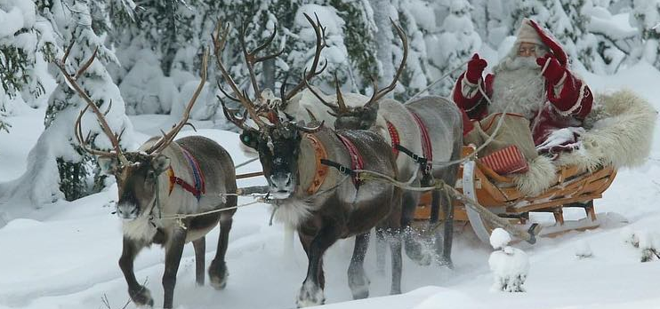 Global Travel Experts santa in his sleigh with reindeers in the snow