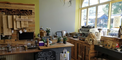 Green Earth Cafe front counter showing coffee machines and coffee products