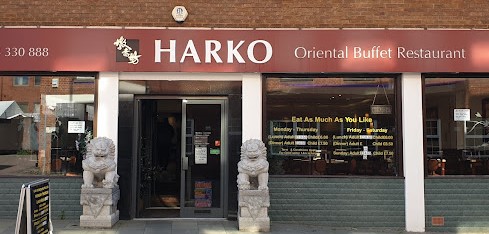 Harko Oriental shopfront with burgundy and white boarding with stone lions at the front door