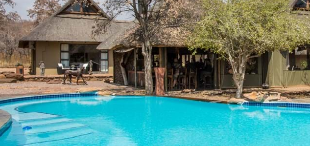 Hays safari tent camp set up in Africa with oval swimming pool