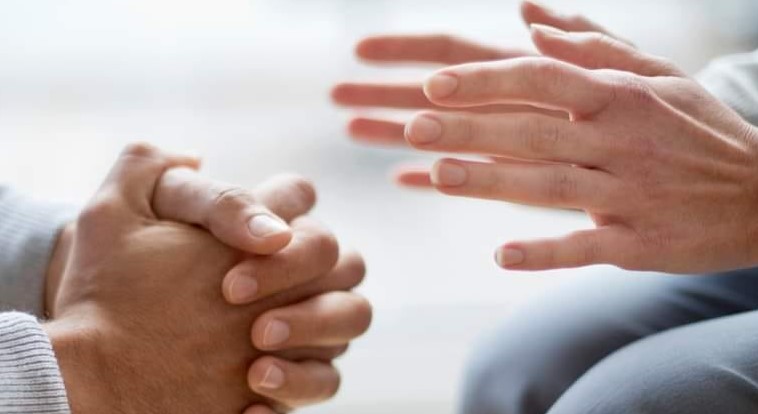 Healthwatch hands of 2 people depicting discussion