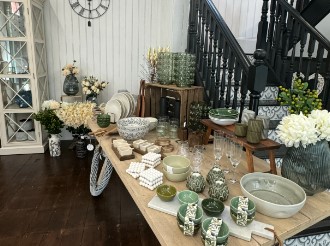 A table laid with beautiful green china for sale at Impakt Interiors.