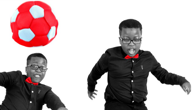 KJ Photography boy with football in black and white with feature red ball and red bow tie