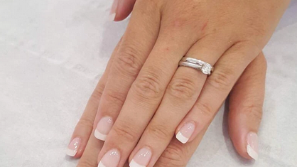 Kels Belles elegant French polished nails with diamond engagement ring and matching wedding band