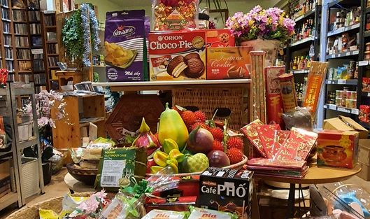 Lotus shop interior with fresh fruit, ingredients, shelves with books, music and Asian accessories