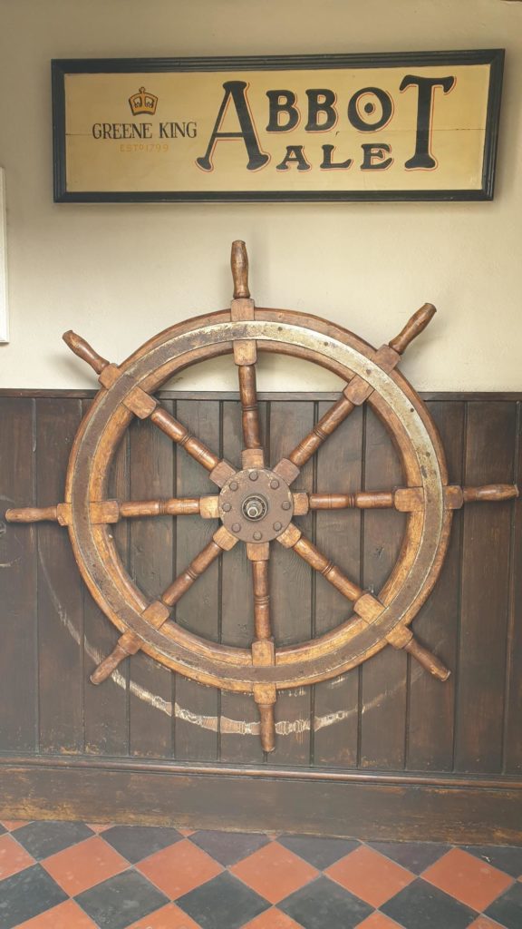 a ships wheel mounted on a wall