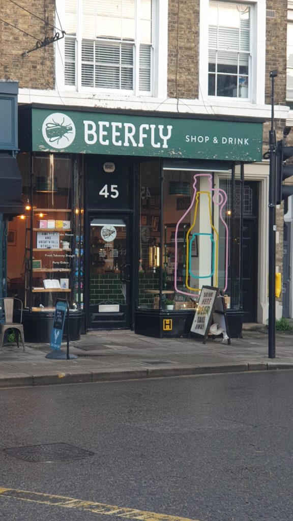Beerfly shop front with green and cream logo and signage