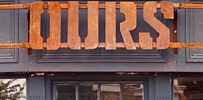 OURS shopfront with industrial frontage and rusted metal sign