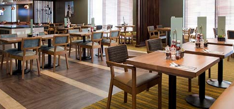 Premier Inn restaurant with timber floow, wooden tables and wooden fabric chairs