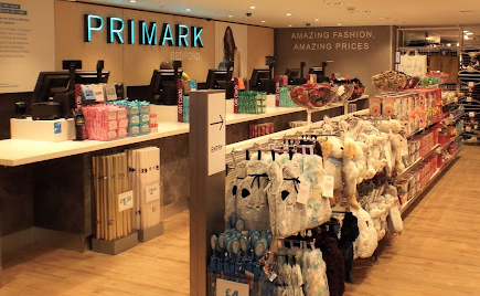 Primark Bedford downstairs pay point showing clothing on rails and accessories