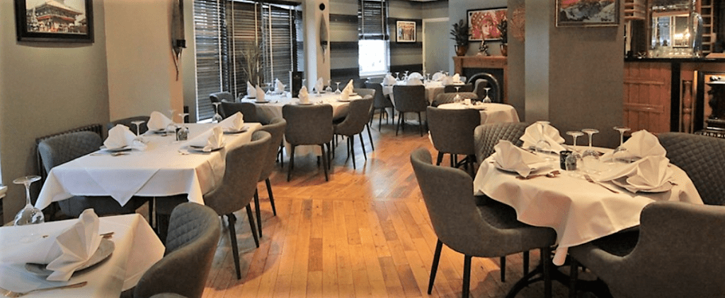 Royal Gurkha tables and chairs, white linen and timber flooring