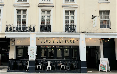 Slug and Lettuce street view with cream board and green writing