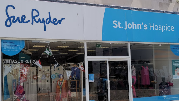 Sue Ryder shopfront with blue and white hoarding
