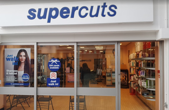 Supercuts Bedford Shopfront blue words on white background