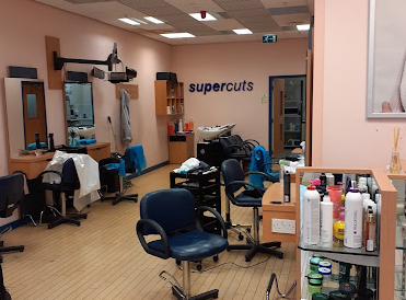 Supercuts interior pink walls, chairs and products