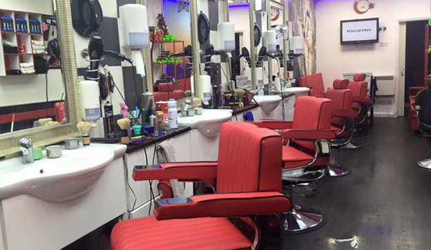The Berber red chairs in black and white tiled salon