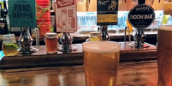 The Rose timber bar with a pint of beer and beer pumps in the background