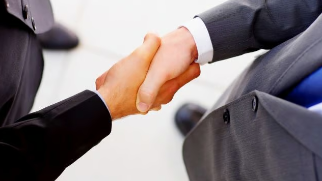 Utilitrack people in suits shaking hands
