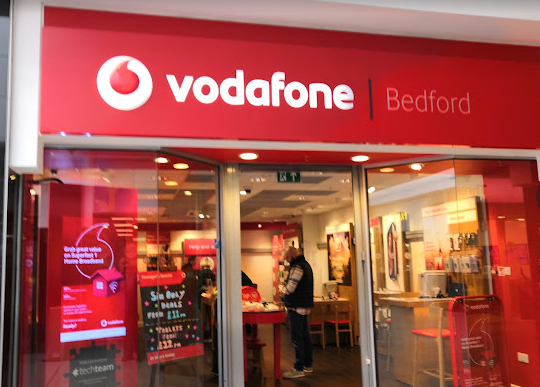 Vodaphone red with white writing Bedford shopfront